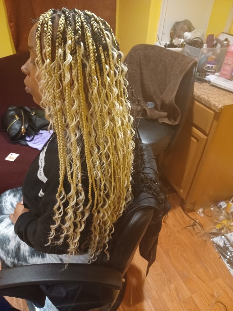 Back view of long, blonde micro-braids